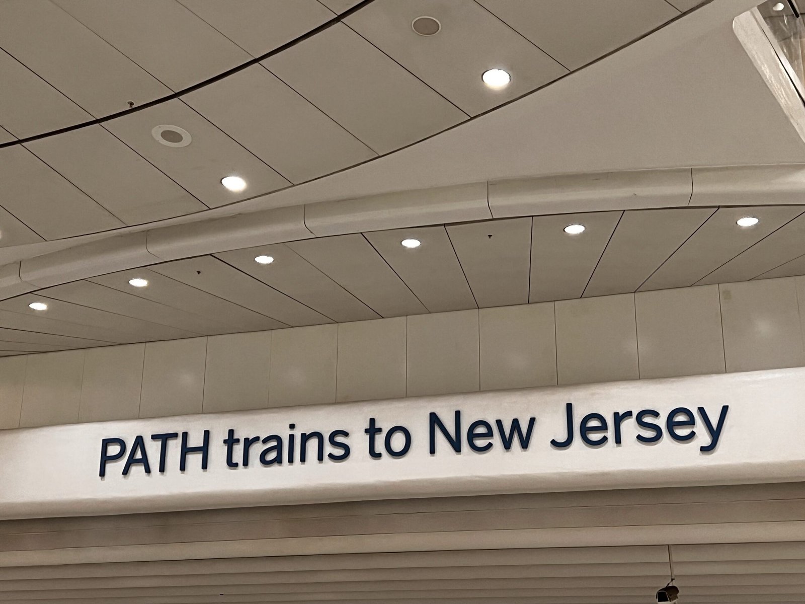 sign pointing to trains from New York to New Jersey