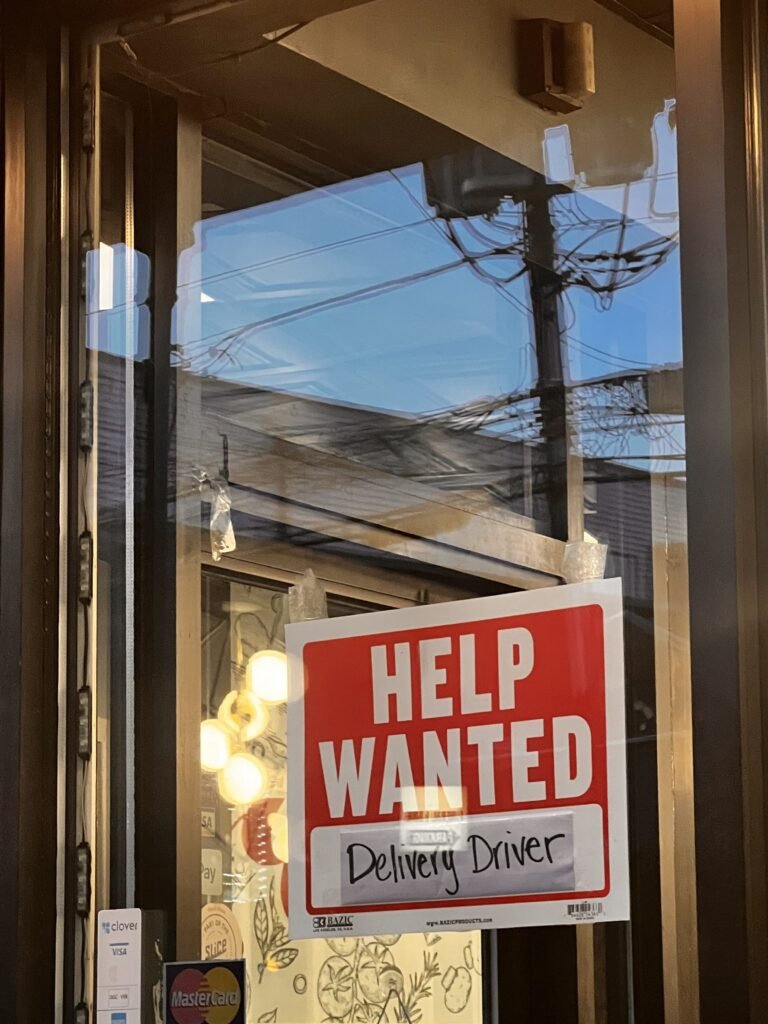 Summer job example Help Wanted deliver driver words in white on red background. 